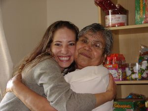 A young woman hugging an older woman