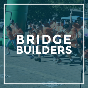 A photo of people running a race with the words "Bridge Builders" overlayed on top